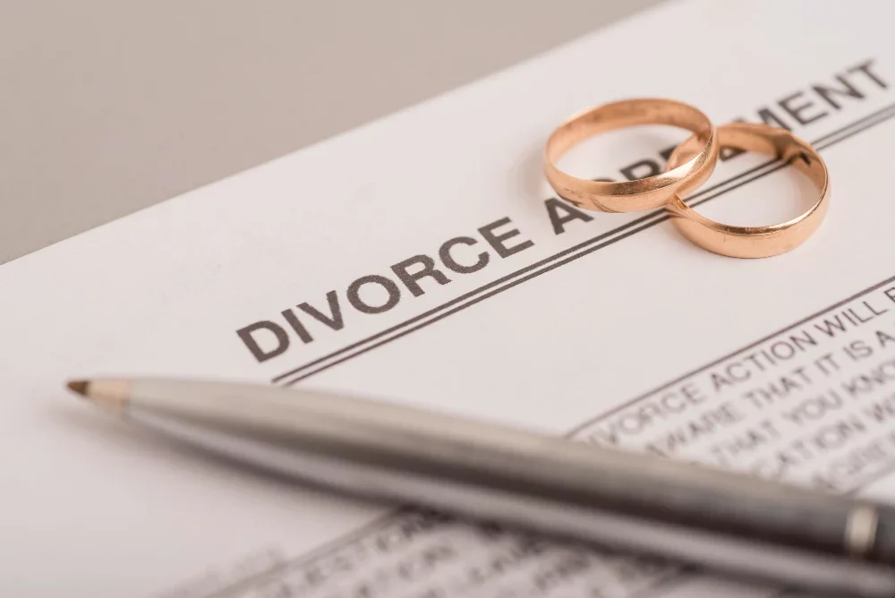 Divorce paper with wedding rings